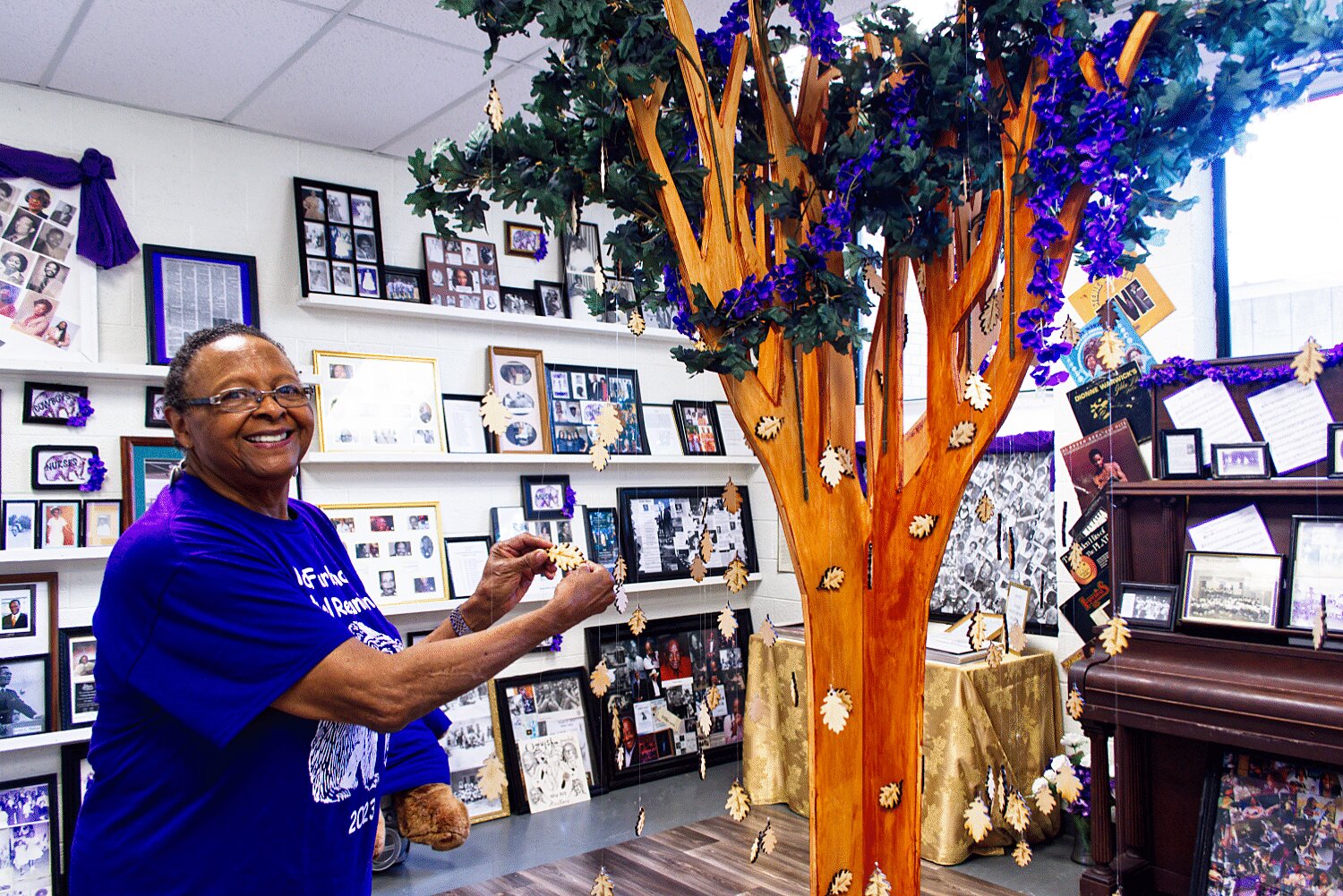 Shirley Bryant Roberson shows the names of families arranged on tree leaves, the center piece of the new McFarland School Museum, which was dedicated during the school’s biennial reunion Friday.